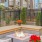a patio with a table and chairs and a fire pit with flowers